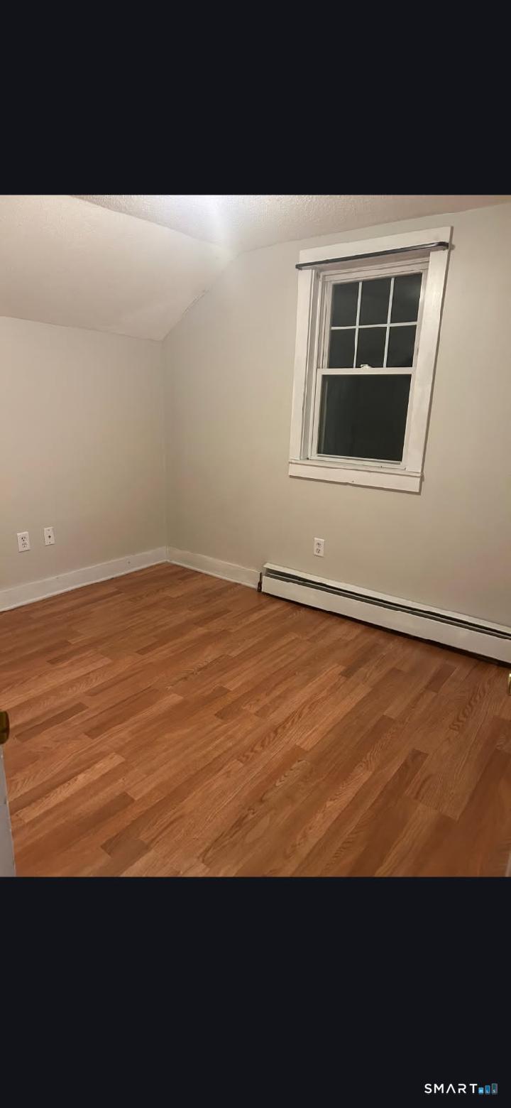 34 Rock Street Winchester, CT 06098 - Photo 16 of 20 a view of an empty room with wooden floor and a window