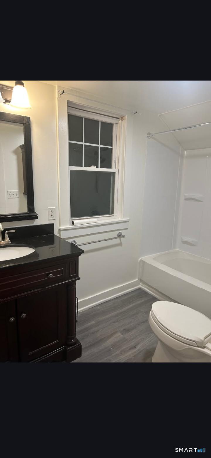 34 Rock Street Winchester, CT 06098 - Photo 19 of 20 a bathroom with a toilet a sink and mirror