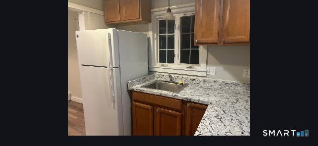 34 Rock Street Winchester, CT 06098 - Photo 2 of 20 a kitchen with granite countertop a refrigerator and a sink