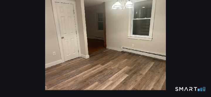 34 Rock Street Winchester, CT 06098 - Photo 4 of 20 a view of an empty room with wooden floor and a window