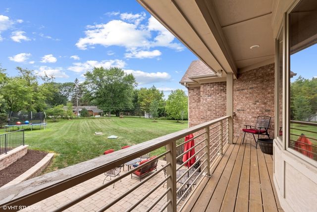 a view of a house with a yard patio and sitting area