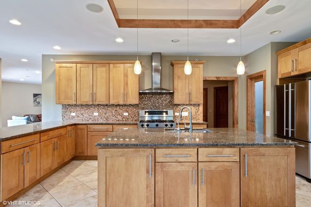 a kitchen with stainless steel appliances granite countertop a sink and cabinets