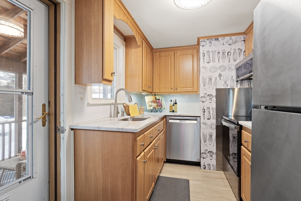 50 Forest Street Reading, MA 01867 - Photo 17 of 42 a kitchen with a sink stove and refrigerator