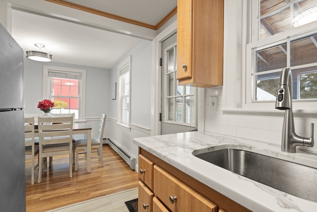 50 Forest Street Reading, MA 01867 - Photo 18 of 42 a kitchen with a sink stove and chairs