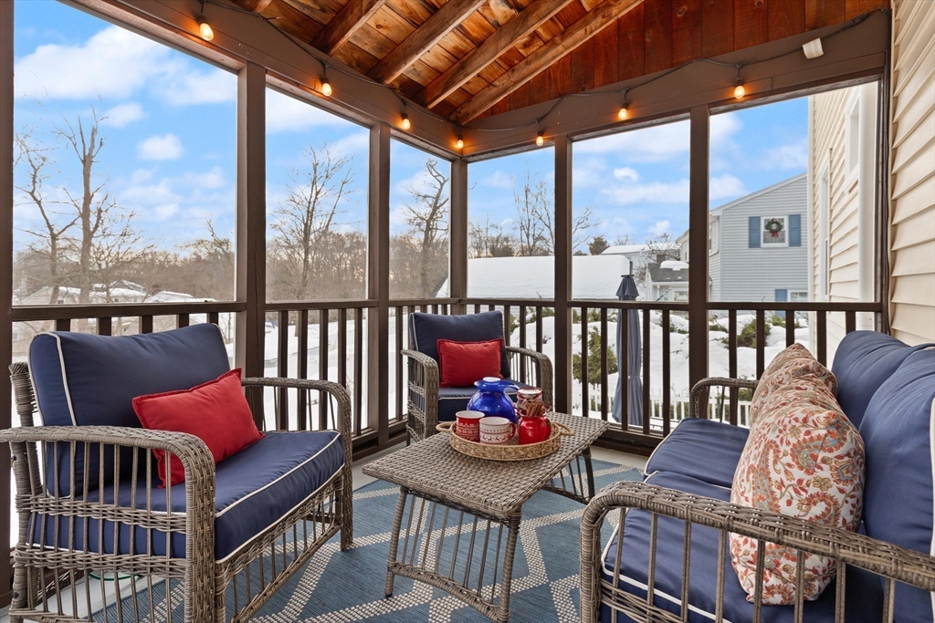 50 Forest Street Reading, MA 01867 - Photo 19 of 42 a balcony with furniture and wooden floor