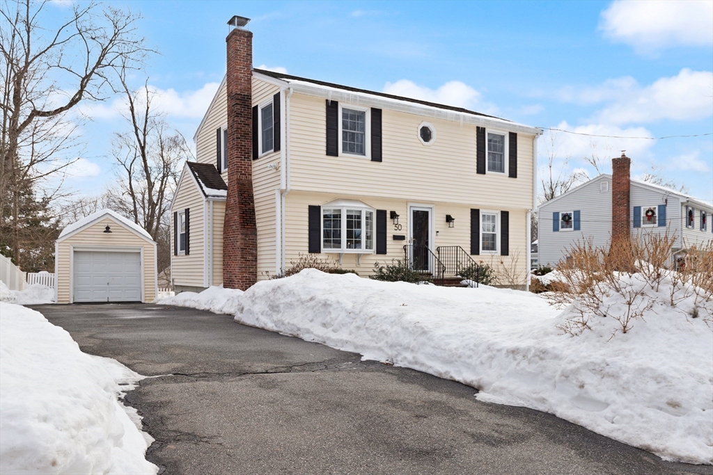 50 Forest Street Reading, MA 01867 - Photo 2 of 42 a front view of a house with a dirt yard