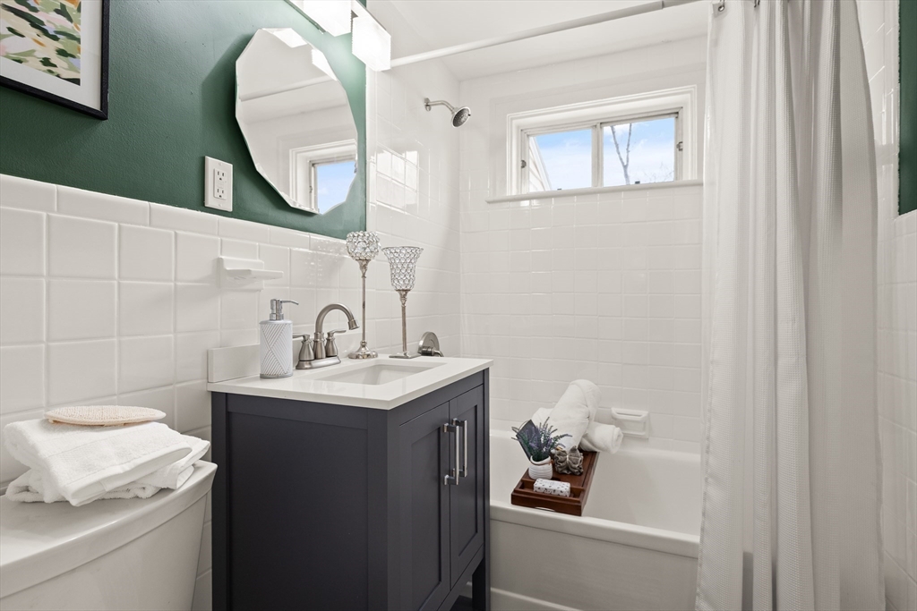 50 Forest Street Reading, MA 01867 - Photo 24 of 42 a bathroom with a sink toilet and a mirror