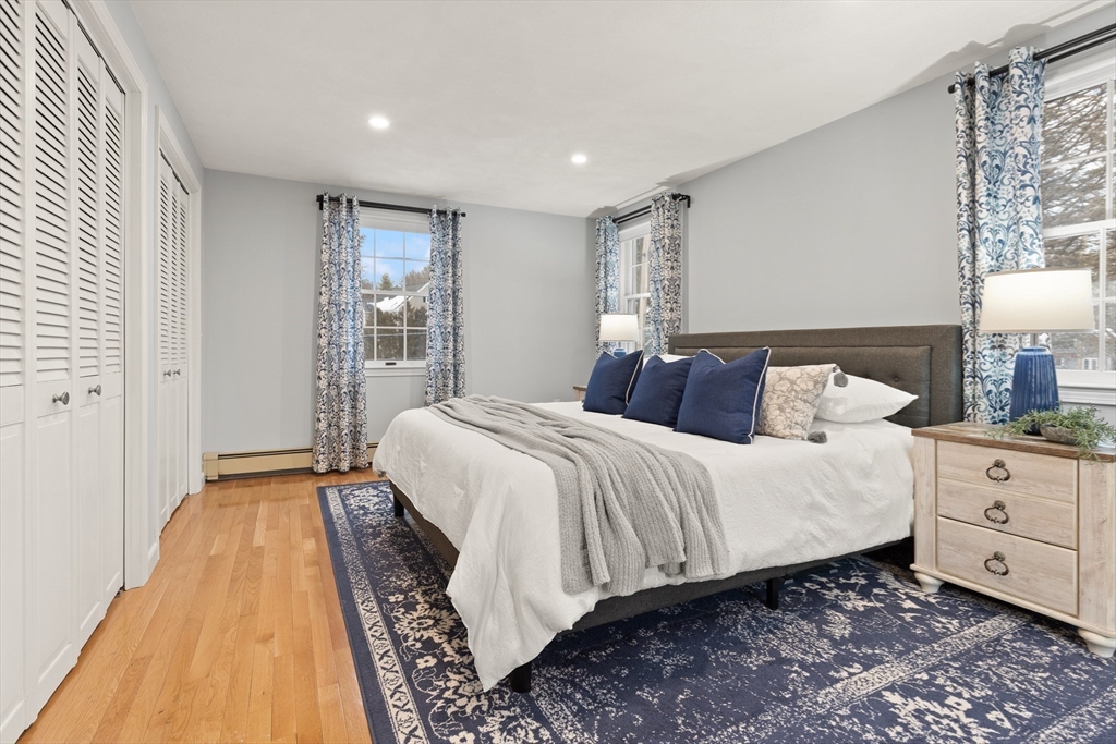 50 Forest Street Reading, MA 01867 - Photo 27 of 42 a bedroom with a large bed and a night stand