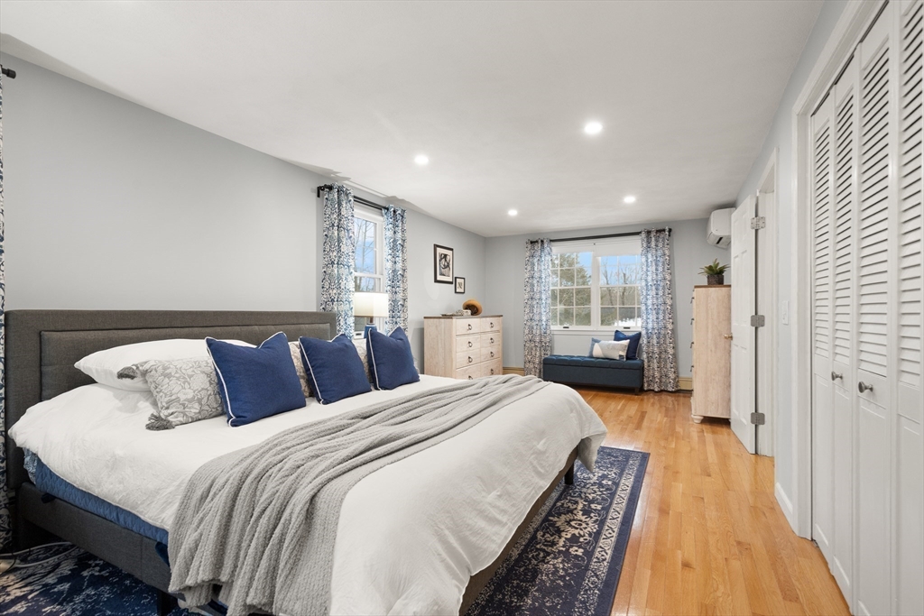 50 Forest Street Reading, MA 01867 - Photo 29 of 42 a spacious bedroom with a bed and a large window