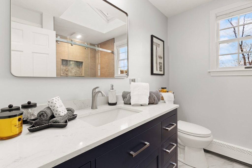 50 Forest Street Reading, MA 01867 - Photo 34 of 42 a bathroom with a sink a toilet and mirror