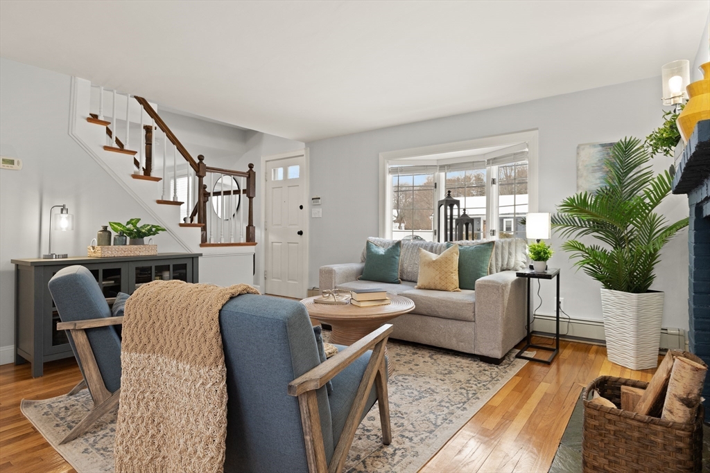 50 Forest Street Reading, MA 01867 - Photo 10 of 42 a living room with furniture potted plant and a window