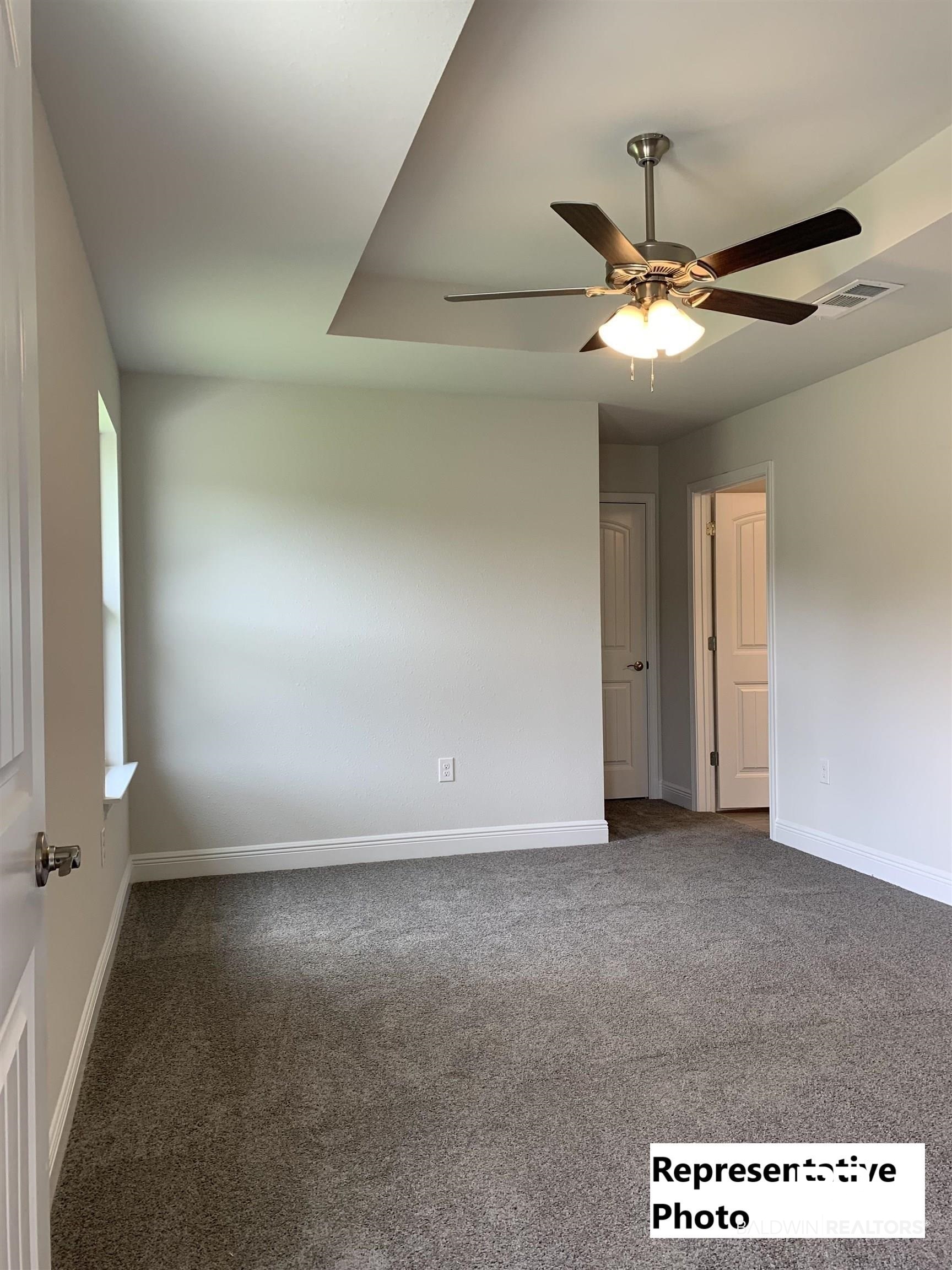 645 Revere Street Foley, AL 36535 - Photo 10 of 14 Empty room with ceiling fan and carpet