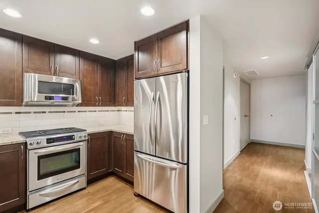 a kitchen with kitchen island a dining table and chairs