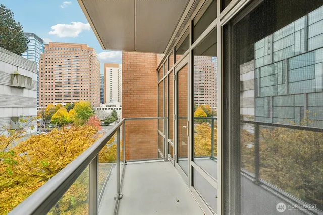 a bedroom with a bed and a flat tv screen on the dresser