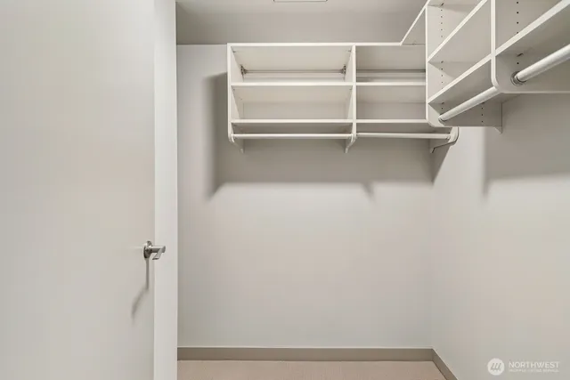 a bathroom with a tub a sink and mirror