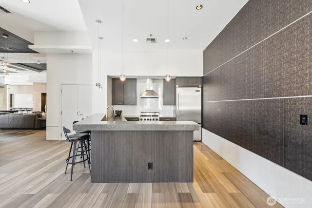 a living room with furniture a large window and wooden floor