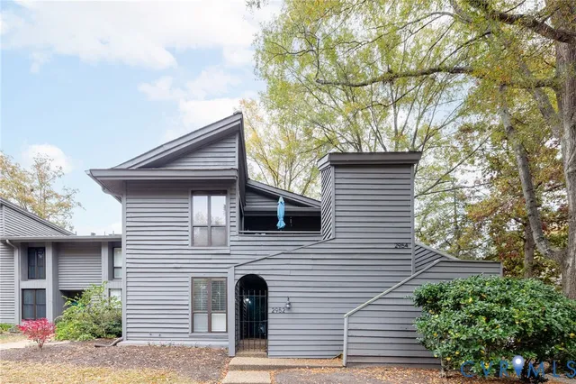 a view of house with a tree