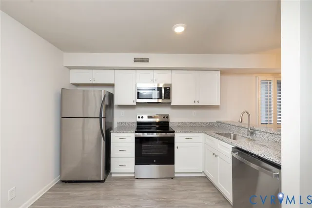 a kitchen with a sink a stove and refrigerator