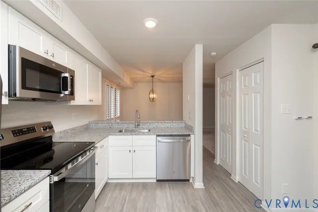 a kitchen with a stove a sink and a microwave