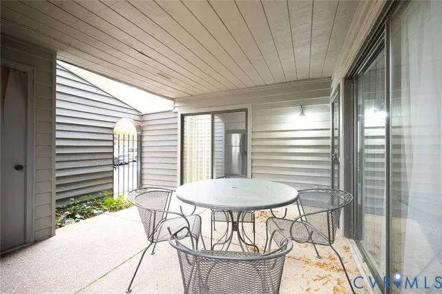 a view of a dining room with furniture and a window