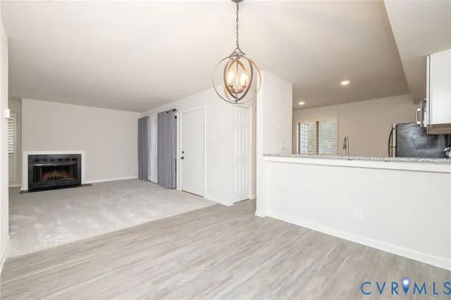 a view of empty room with wooden floor and window