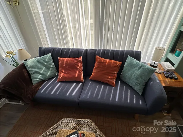 a couch sitting in a bedroom next to a window