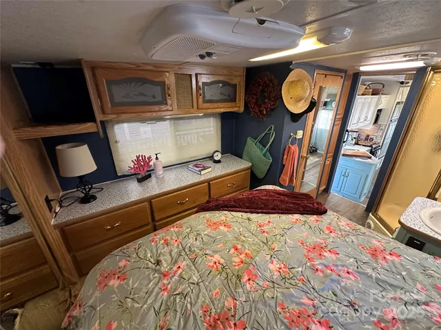 a bedroom with bed and wooden floor