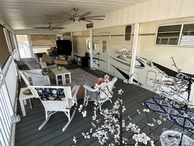 a view of a dining room with furniture a rug and wooden floor