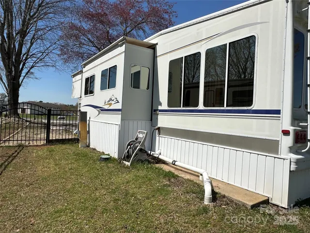 a view of a house with backyard and a fence