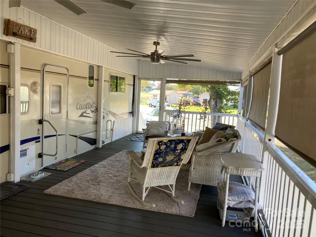 a living room with large windows a rug and a floor to ceiling window