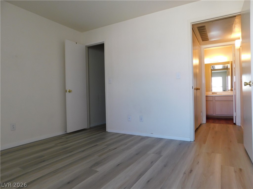 5221 South Lindell Road, Unit 202 Las Vegas, NV 89118 - Photo 24 of 28 Newly installed wood flooring provides a contemporary aesthetic throughout this cozy primary bedroom.