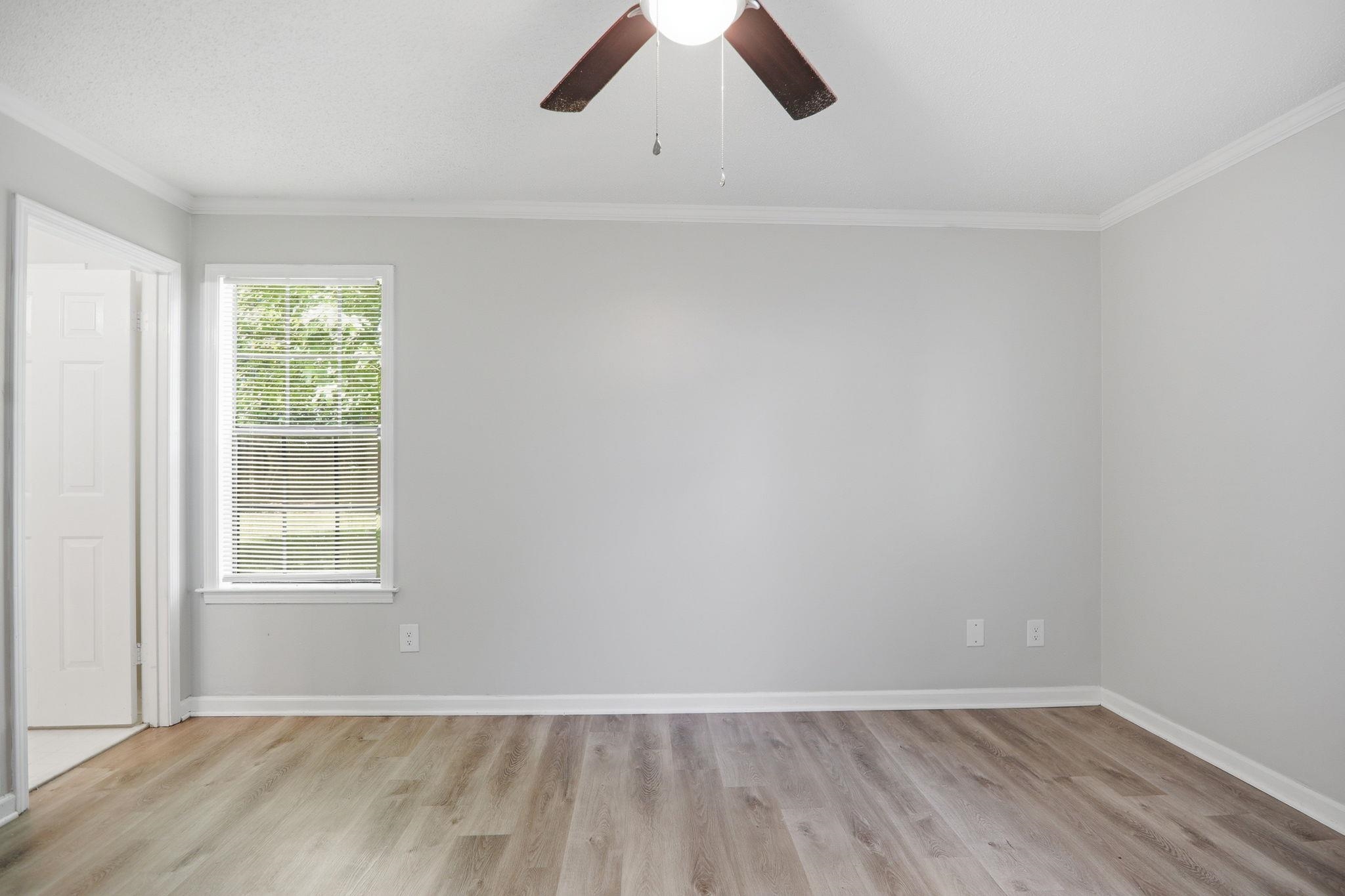 3113 Raleigh Ridge Cove Memphis, TN 38128 - Photo 25 of 38 Light-filled room featuring wood-finish flooring, a ceiling fan, crown molding, and a window with horizontal blinds