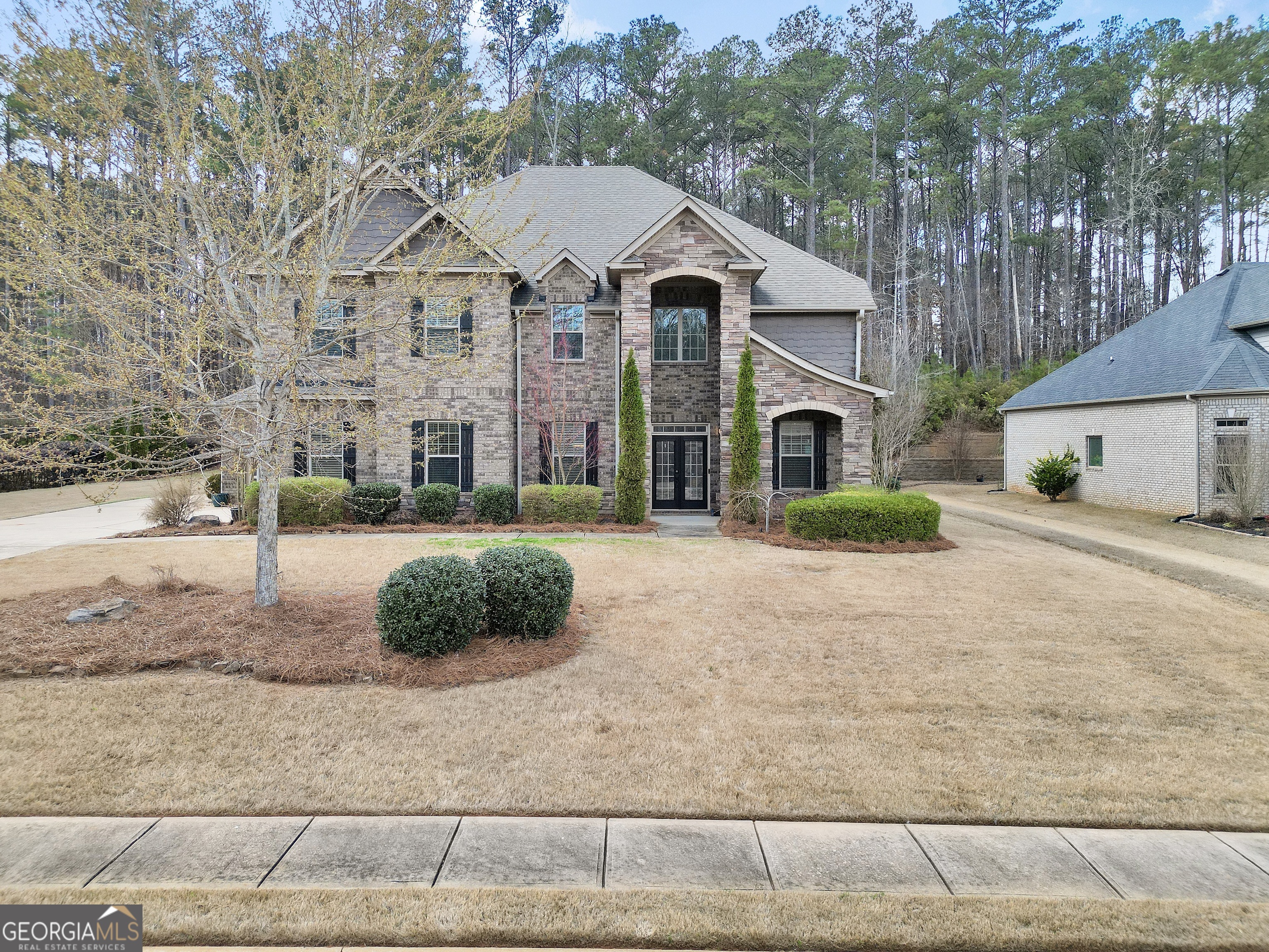 a front view of a house with a yard and garage