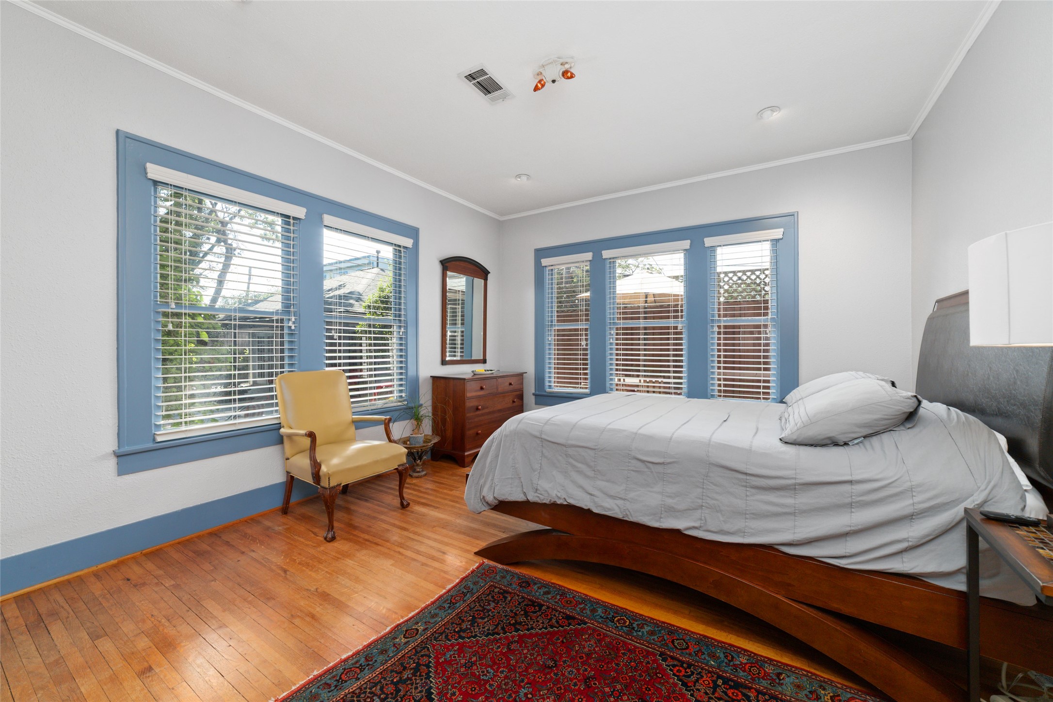 1613 California Street Houston, TX 77006 - Photo 22 of 50 Filled with natural light and overlooking the pool, patio, and gardens, this inviting guest bedroom offers peaceful views in every season. Original one-inch hardwood floors, generous proportions, and two closets, including one cedar-lined, continue the home's tradition of thoughtful craftsmanship.