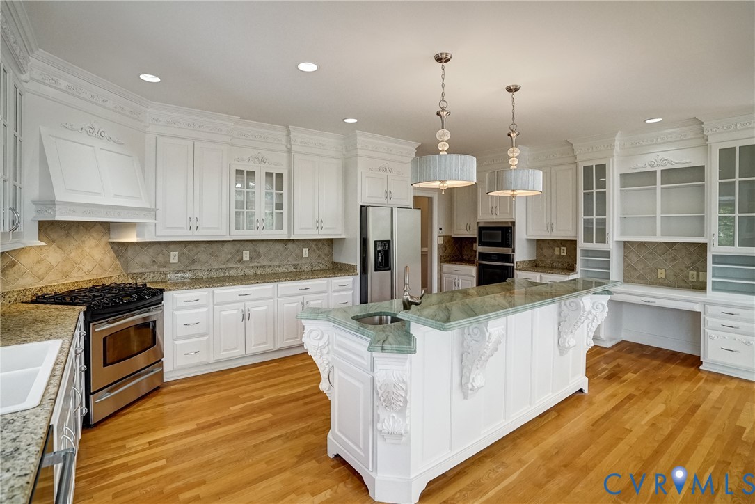 721 Meadow View Ridge Manakin-Sabot, VA 23103 - Photo 18 of 45 a kitchen with stainless steel appliances granite countertop a stove a sink and a refrigerator