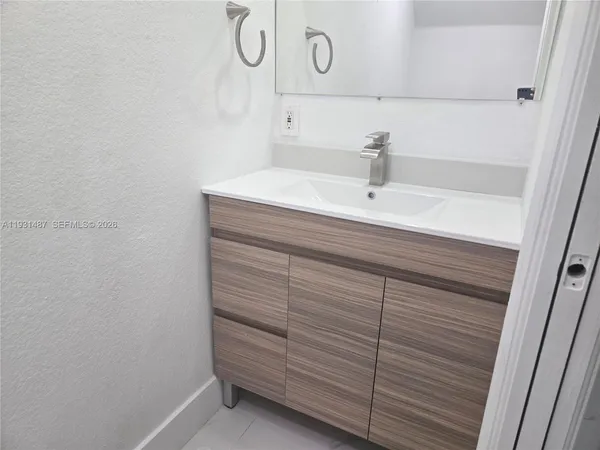 a bathroom with a sink and vanity