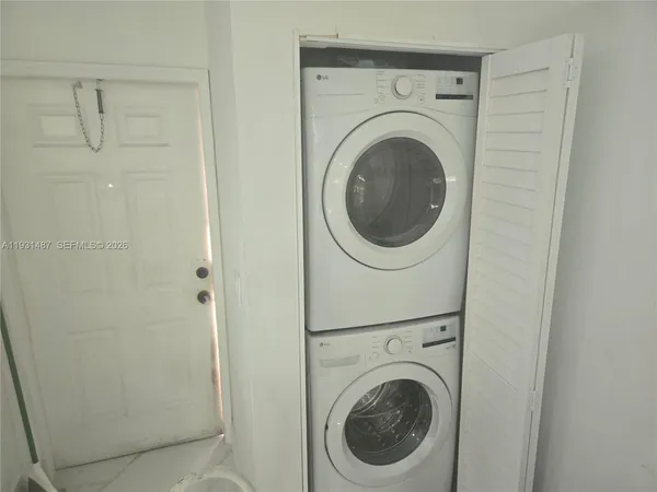 a view of a hallway with washer and dryer