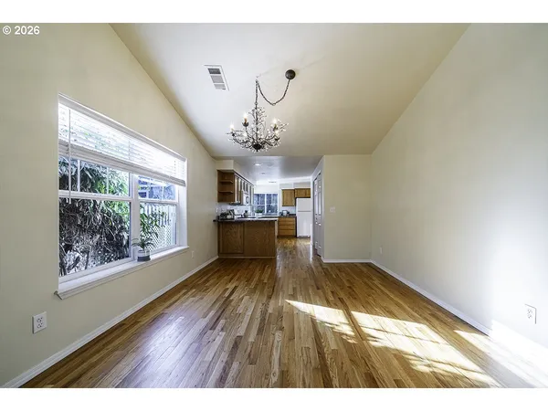a view of a room with window and wooden floor