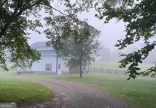a view of a swimming pool with a yard