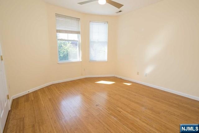 199 Van Winkle Street, Unit 2 East Rutherford, NJ 07073 - Photo 15 of 22 an empty room with wooden floor and windows