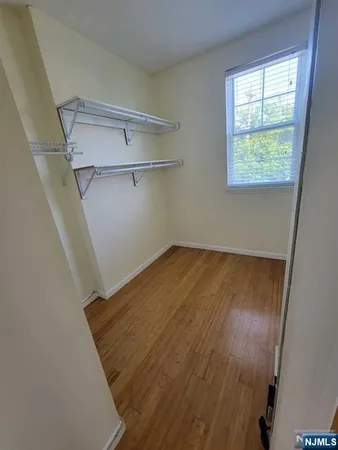 a view of a room with wooden floor