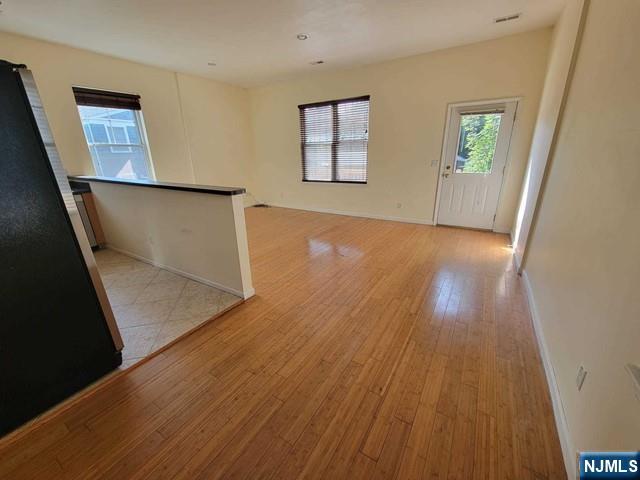 199 Van Winkle Street, Unit 2 East Rutherford, NJ 07073 - Photo 5 of 22 wooden floor in an empty room with a window
