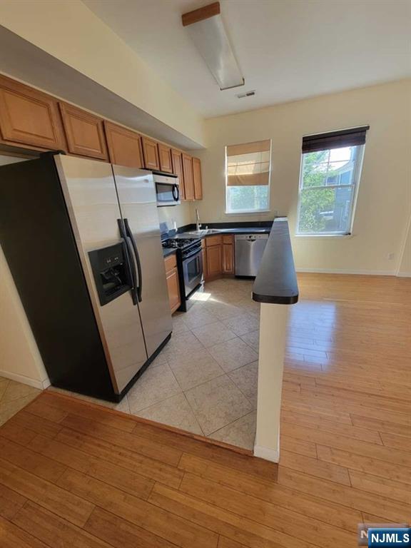 199 Van Winkle Street, Unit 2 East Rutherford, NJ 07073 - Photo 7 of 22 a living room with furniture and a flat screen tv