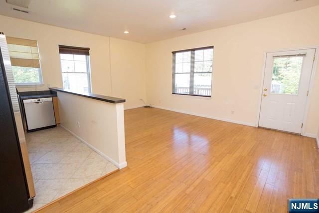199 Van Winkle Street, Unit 2 East Rutherford, NJ 07073 - Photo 8 of 22 an empty room with wooden floor and windows