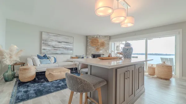 a kitchen with white cabinets and sink