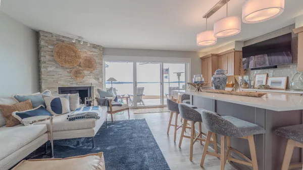 a living room with furniture a fireplace and a flat screen tv