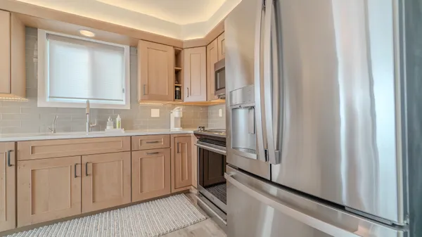 a kitchen with white cabinets and a sink