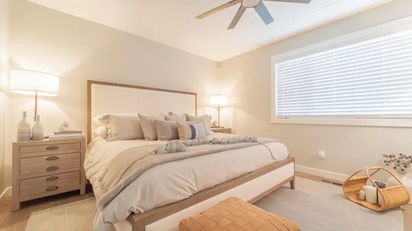 a bedroom with a bed and a window