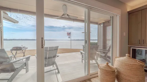 a living room with furniture a floor to ceiling window and outdoor view