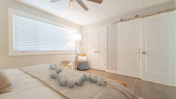a bedroom with a bed and a window